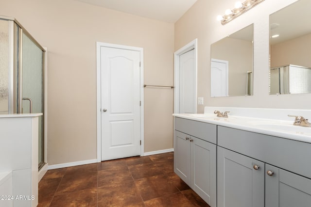 bathroom featuring vanity and an enclosed shower