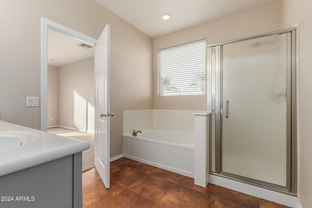 bathroom featuring tile patterned flooring, vanity, and independent shower and bath