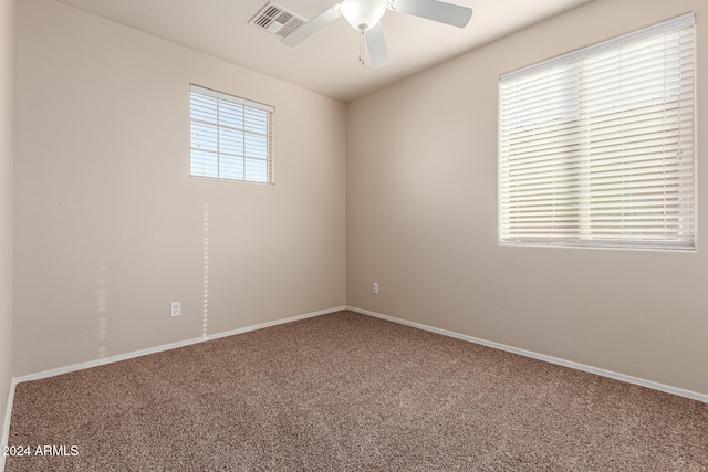 carpeted spare room featuring ceiling fan