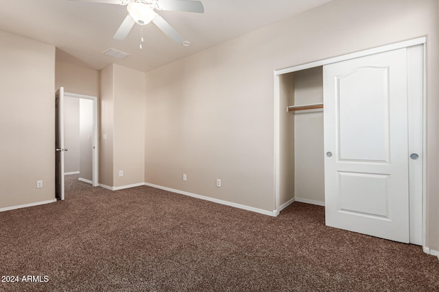 unfurnished bedroom with ceiling fan, a closet, and dark carpet