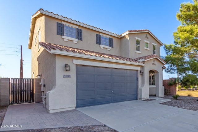 mediterranean / spanish-style home featuring a garage