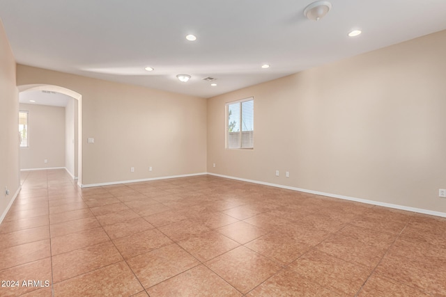 unfurnished room featuring light tile patterned floors