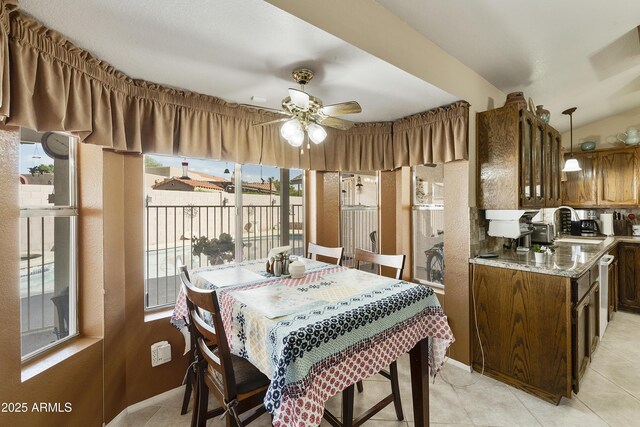 dining space featuring ceiling fan and light tile patterned flooring