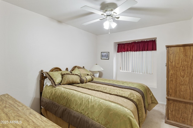 bedroom with ceiling fan and light colored carpet