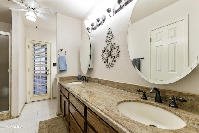 bathroom featuring double vanity, a ceiling fan, a sink, and tile patterned floors