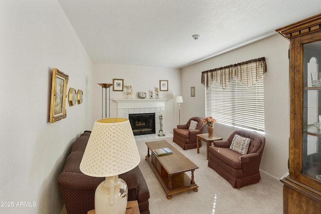 living area with light carpet, a fireplace, and baseboards