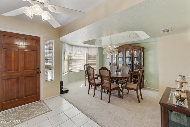 dining room with light colored carpet, visible vents, light tile patterned flooring, a textured ceiling, and baseboards