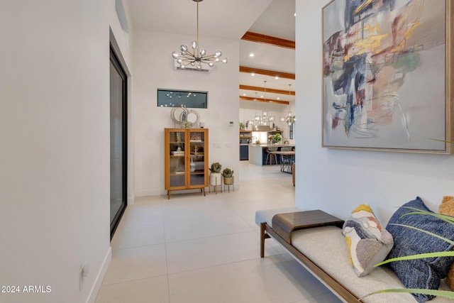 corridor featuring beam ceiling, a notable chandelier, recessed lighting, a high ceiling, and tile patterned floors