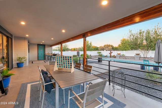 view of patio featuring a fenced in pool, outdoor dining area, and a fenced backyard