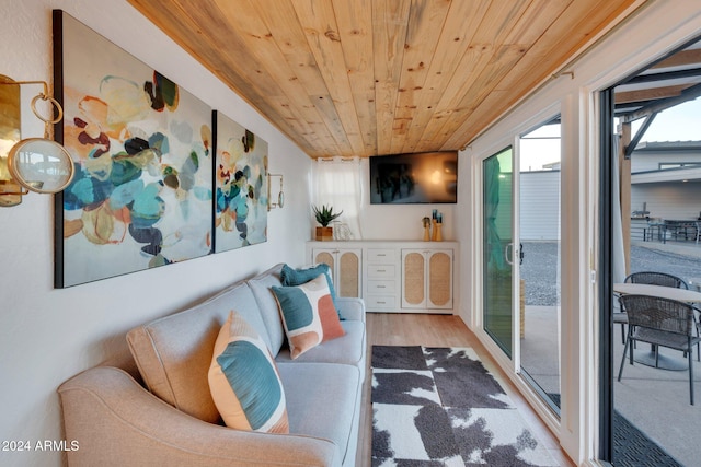 living area with wood ceiling and wood finished floors