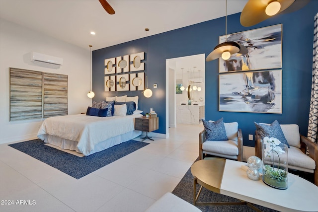 bedroom with ensuite bathroom, a wall mounted AC, ceiling fan, baseboards, and tile patterned floors