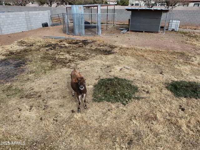 view of yard with an outdoor structure and fence