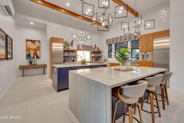 kitchen with modern cabinets, a kitchen island, stainless steel refrigerator, an AC wall unit, and open shelves