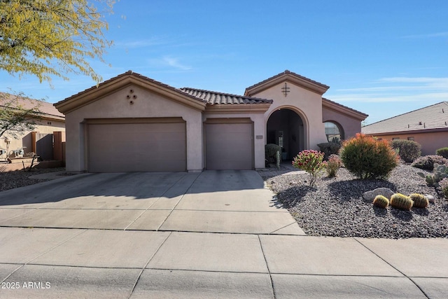 mediterranean / spanish-style home with a garage