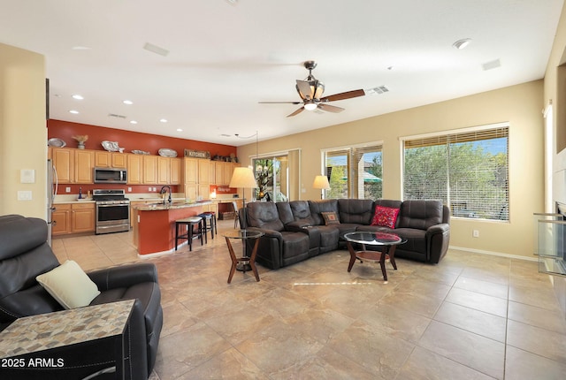 living room with ceiling fan and sink