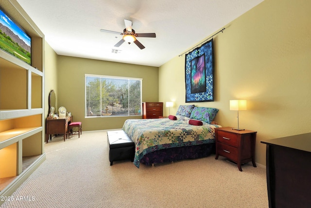 bedroom with ceiling fan and light colored carpet