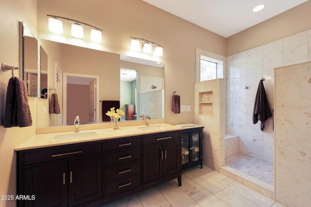 bathroom featuring vanity and a tile shower