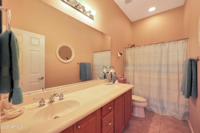 bathroom with toilet, tile patterned floors, and vanity