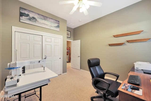 carpeted office featuring ceiling fan