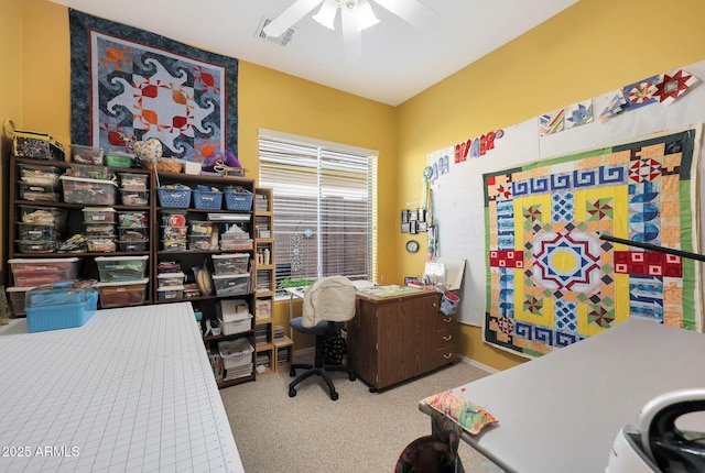 carpeted office space featuring ceiling fan