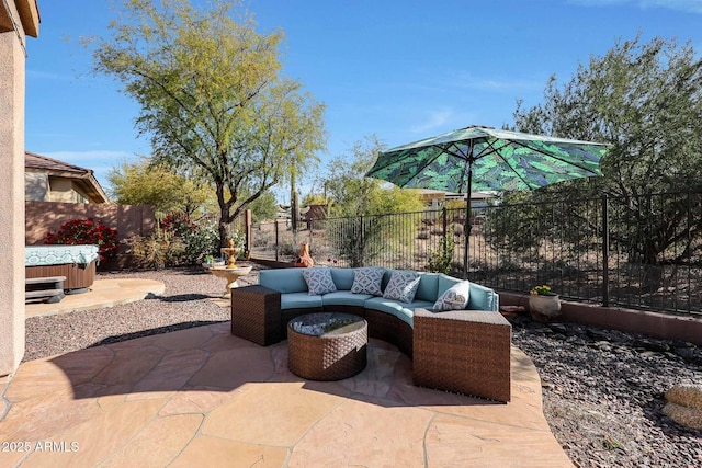 view of patio / terrace with an outdoor hangout area and a hot tub