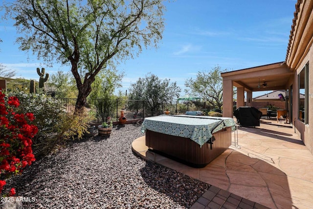 view of yard featuring ceiling fan, a patio area, and a hot tub