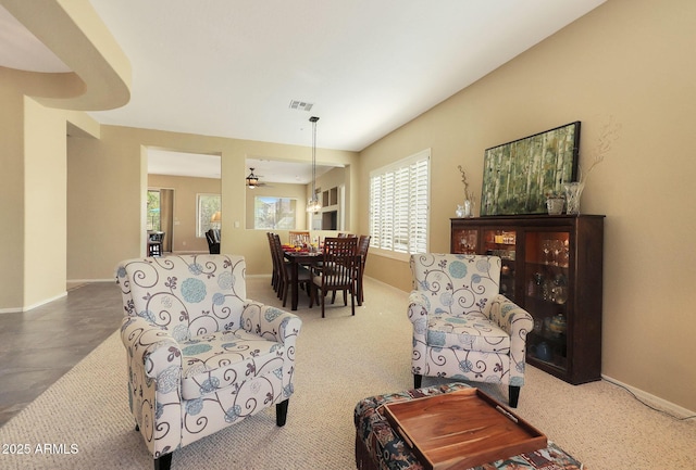 living room with ceiling fan and carpet