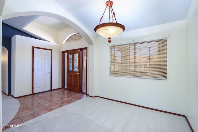 entryway featuring a healthy amount of sunlight and carpet floors