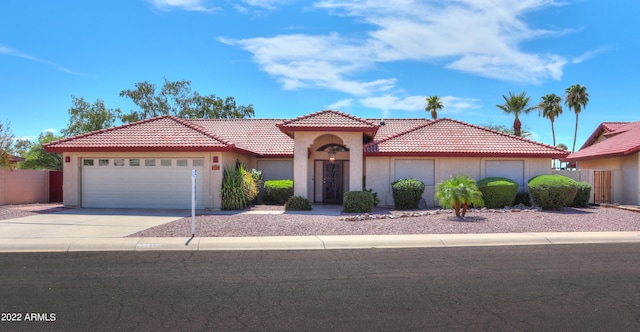 mediterranean / spanish-style home with a garage