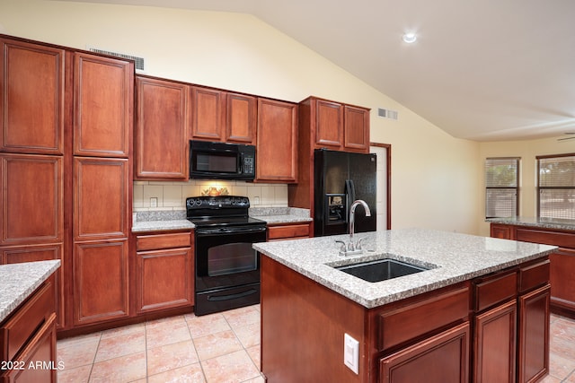 kitchen with sink, tasteful backsplash, black appliances, vaulted ceiling, and a kitchen island with sink