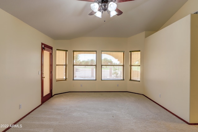 carpeted empty room featuring vaulted ceiling and ceiling fan