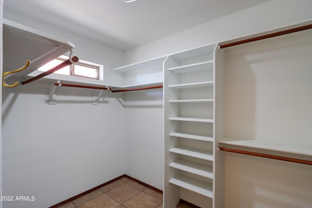 spacious closet featuring light tile flooring