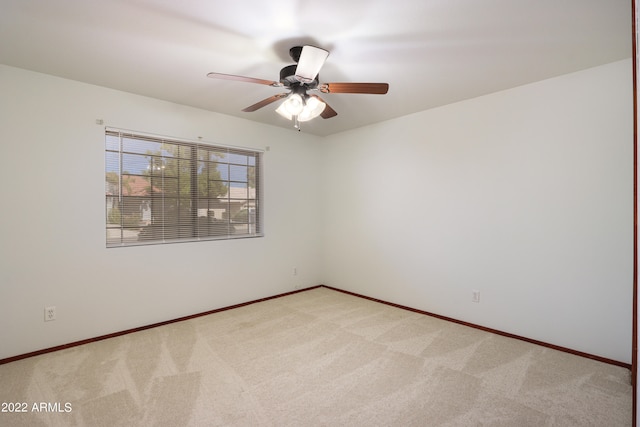 empty room with ceiling fan and carpet