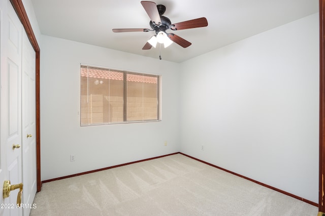 unfurnished room with carpet and ceiling fan