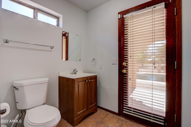 bathroom with tile floors, vanity, and toilet