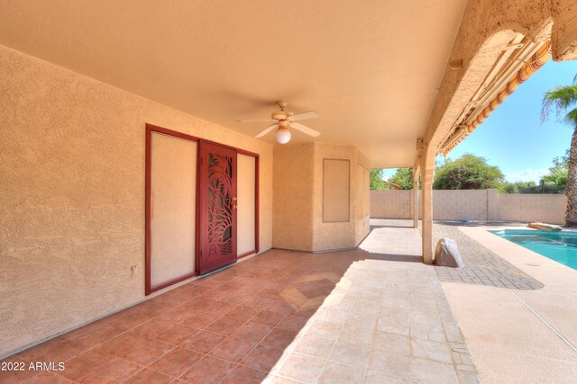 view of patio / terrace with ceiling fan and a fenced in pool