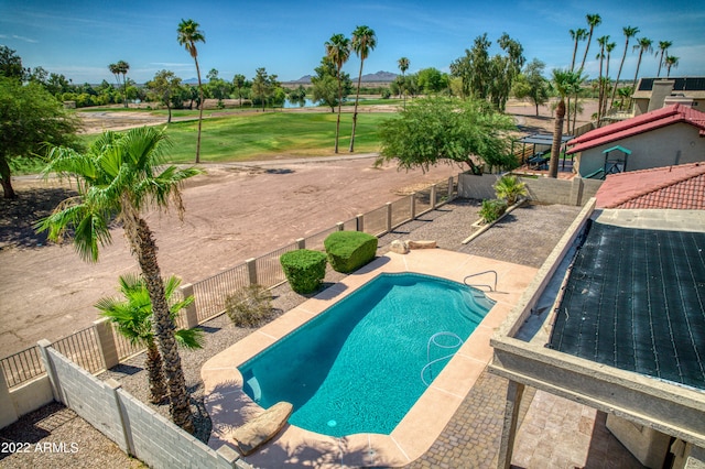 view of pool with a patio area and a yard