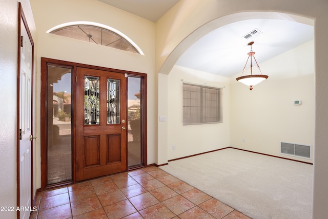 foyer with carpet flooring