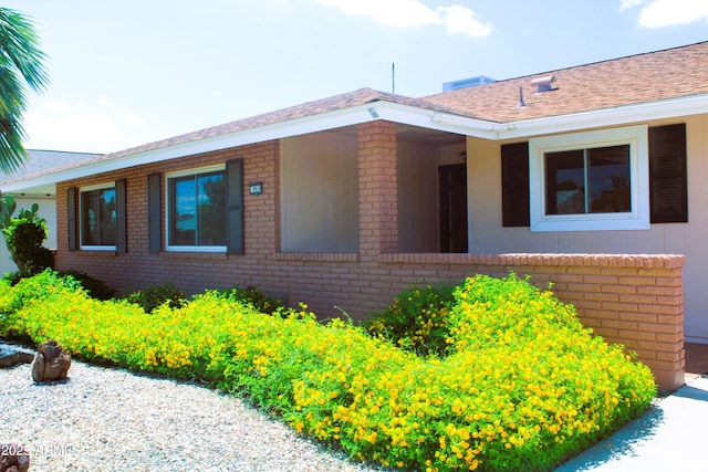 9939 W Ironwood Dr, Sun City, AZ 85351 - view of front of property with brick siding and roof with shingles