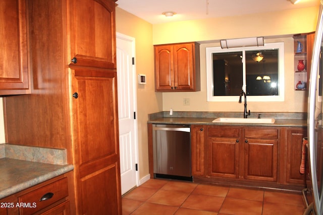 9939 W Ironwood Dr, Sun City, AZ 85351 - kitchen featuring dishwasher, light tile patterned floors, brown cabinetry, and dark countertops