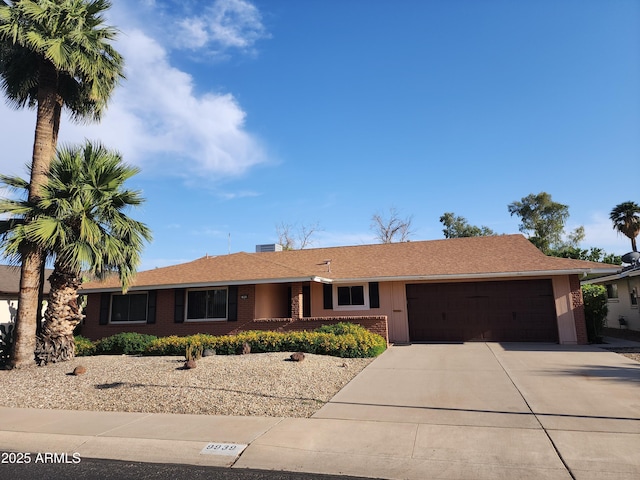 9939 W Ironwood Dr, Sun City, AZ 85351 - single story home with a garage, brick siding, and driveway