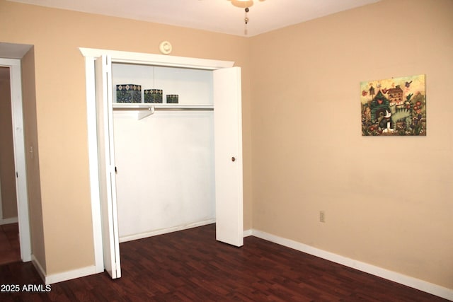 9939 W Ironwood Dr, Sun City, AZ 85351 - unfurnished bedroom featuring dark wood finished floors and a closet