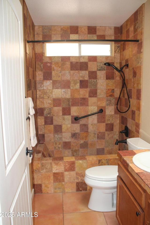 9939 W Ironwood Dr, Sun City, AZ 85351 - bathroom with tiled shower, vanity, and tile patterned flooring