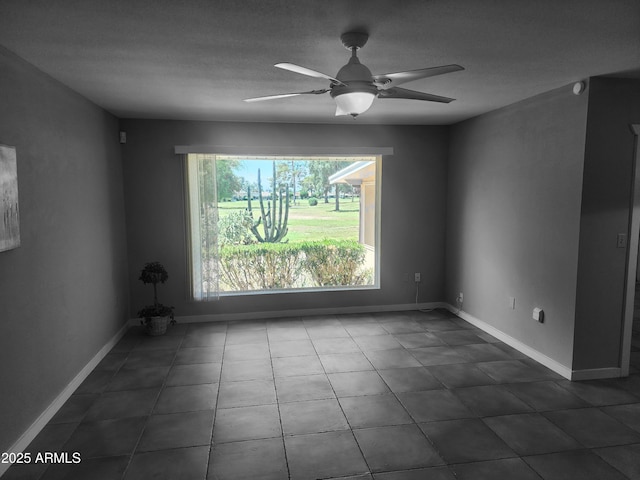 9939 W Ironwood Dr, Sun City, AZ 85351 - unfurnished room with a ceiling fan and dark tile patterned floors