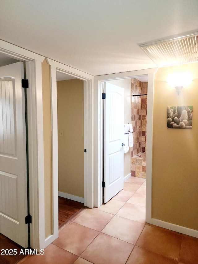 9939 W Ironwood Dr, Sun City, AZ 85351 - hallway with light tile patterned floors