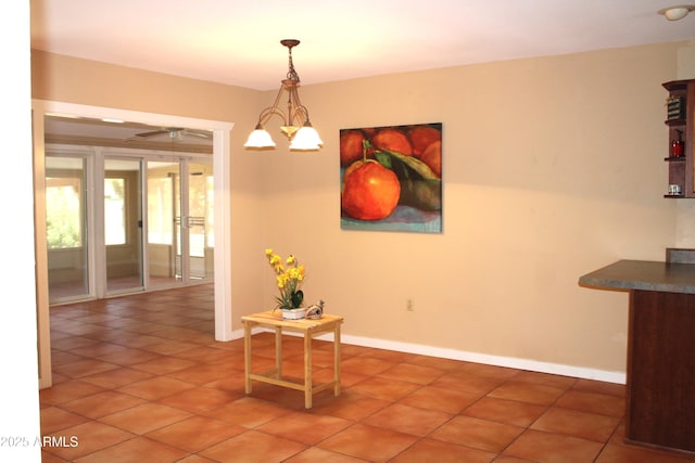9939 W Ironwood Dr, Sun City, AZ 85351 - dining space with light tile patterned floors and a chandelier