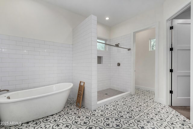 bathroom with tile patterned floors and separate shower and tub