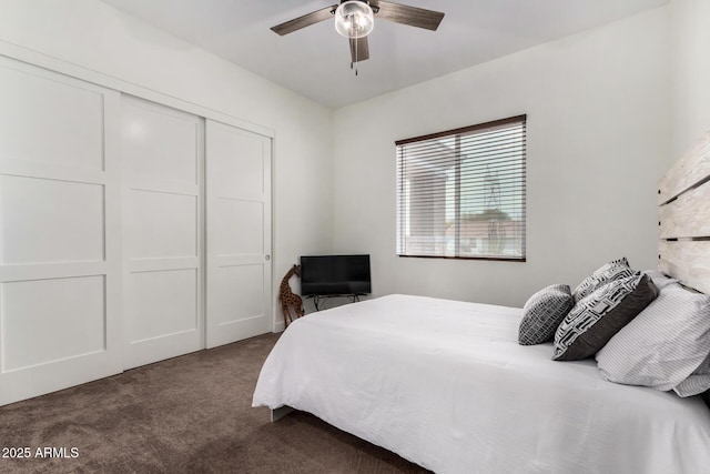 carpeted bedroom featuring ceiling fan and a closet