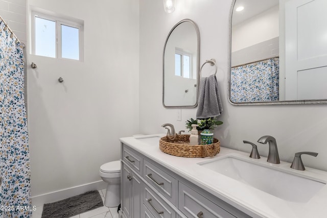 bathroom featuring walk in shower, vanity, and toilet