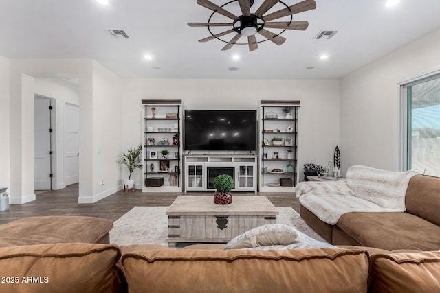 living room with ceiling fan and dark hardwood / wood-style floors